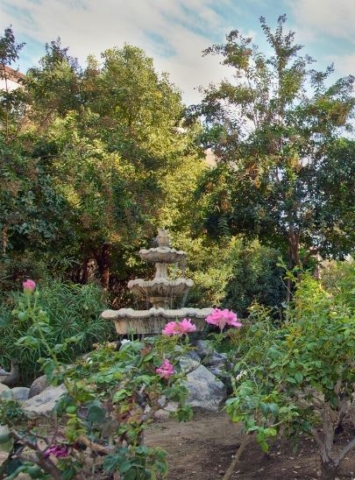 Fountain and Rose Garden at The Oaks of Pasadena — A Top-Rated Senior Living Community Since 1981 Beautiful fountain surrounded by roses at The Oaks of Pasadena senior living community, offering a peaceful garden retreat for residents